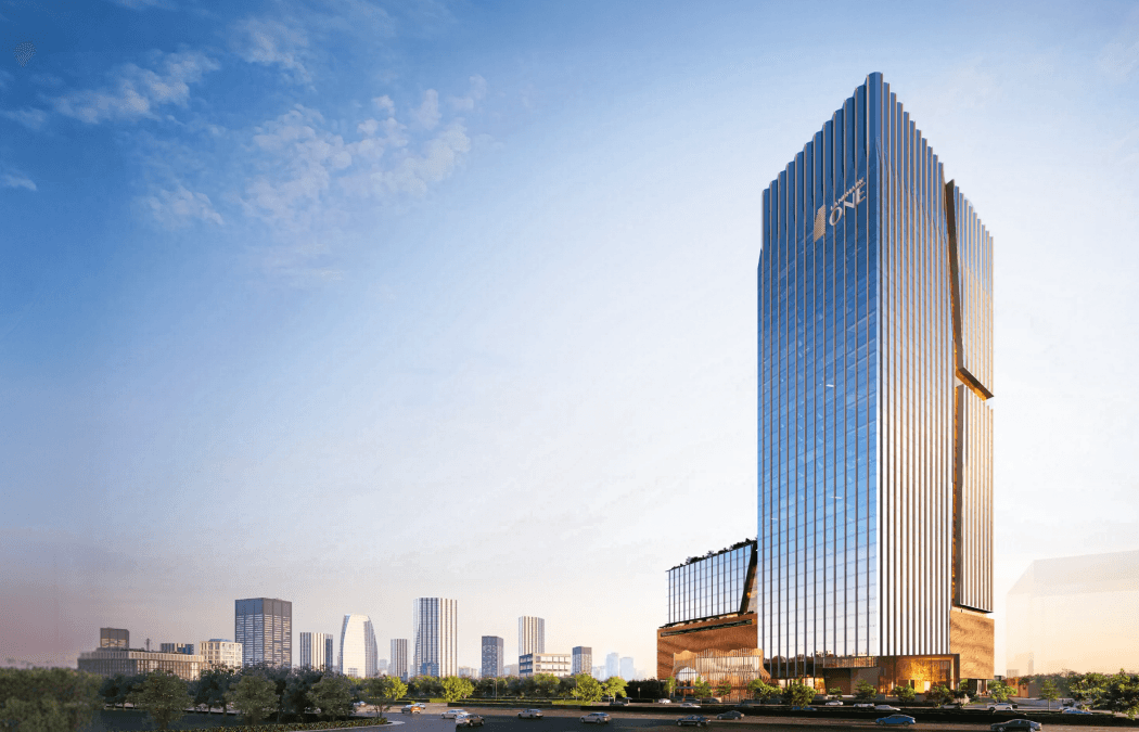 The tower against the skyline, podium lit at its base