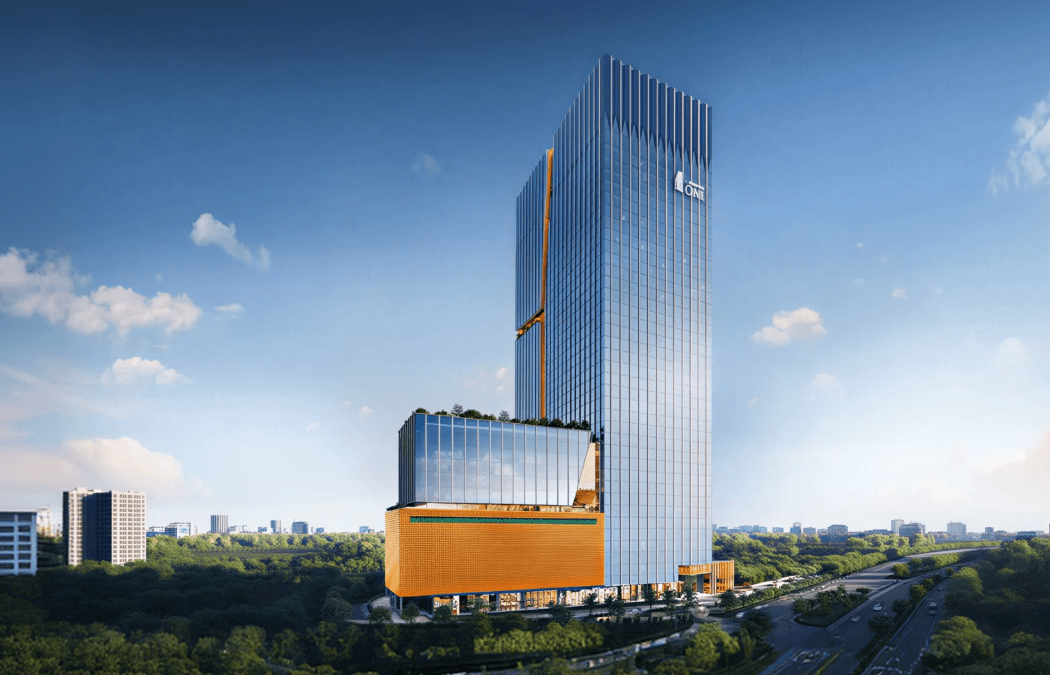 Tower and orange retail podium seen across the treeline