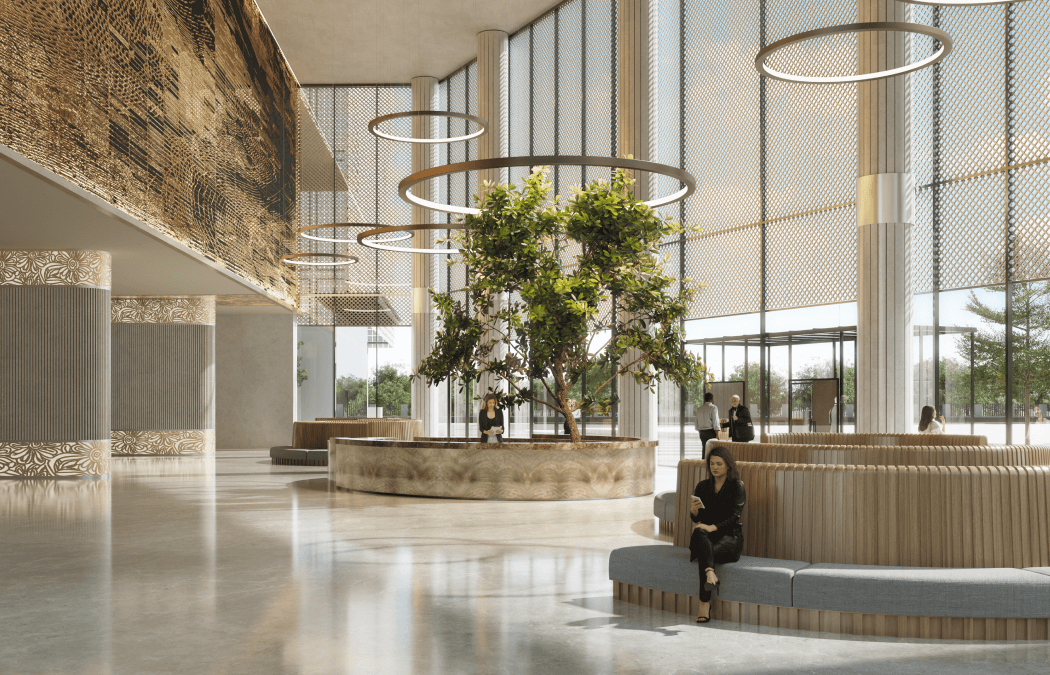 Double-height lobby with planted island and ring lighting